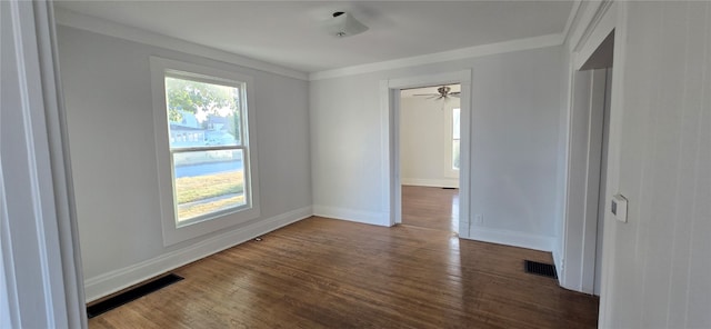 spare room with ornamental molding, dark hardwood / wood-style floors, and ceiling fan