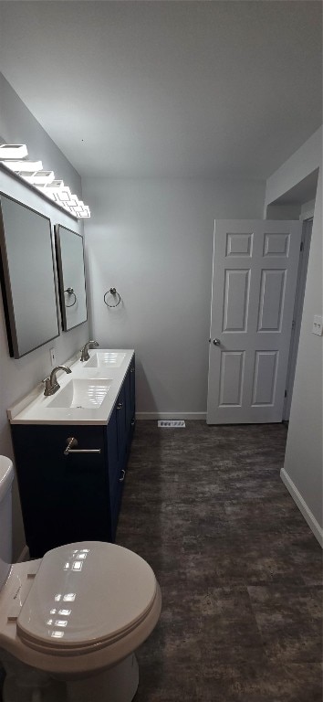 bathroom featuring toilet and vanity