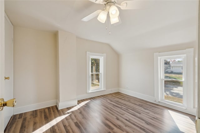 additional living space with hardwood / wood-style floors, vaulted ceiling, and ceiling fan