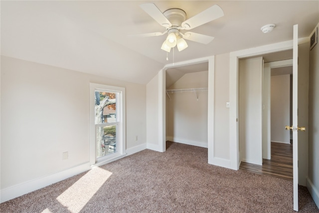 unfurnished bedroom with a closet, ceiling fan, carpet flooring, and lofted ceiling