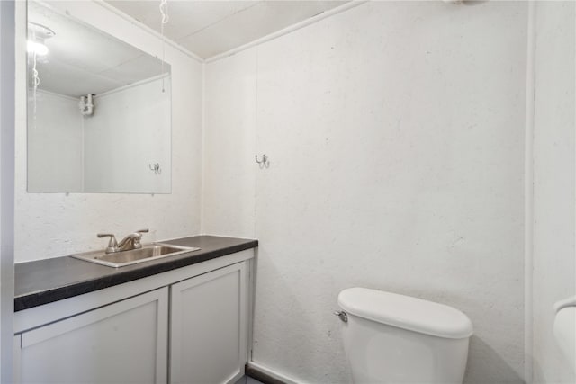 bathroom featuring toilet and vanity