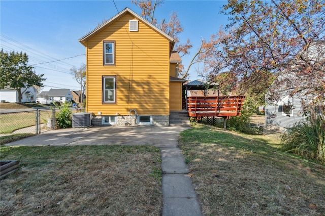 view of property exterior with central air condition unit, a gazebo, a lawn, and a patio