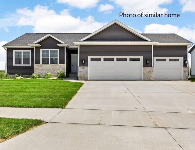 craftsman-style home with a front yard and a garage