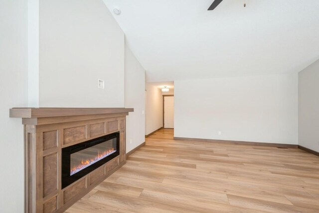 unfurnished living room with ceiling fan and light hardwood / wood-style flooring