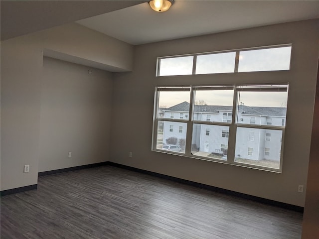 empty room featuring dark hardwood / wood-style flooring