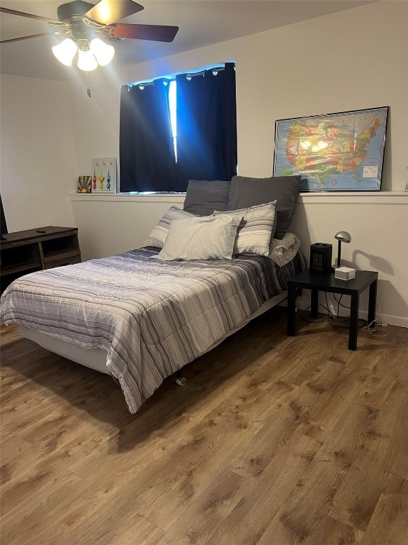 bedroom with hardwood / wood-style floors and ceiling fan