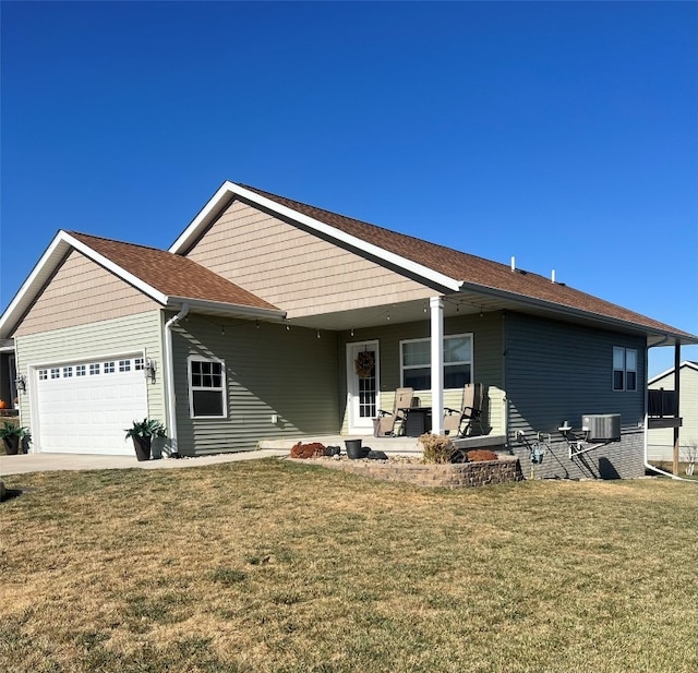 single story home with central AC, a front lawn, and a garage