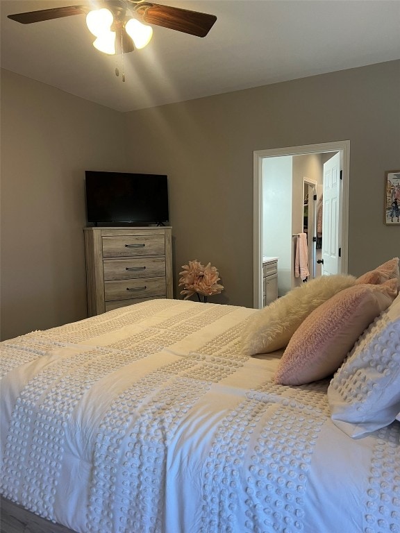 bedroom featuring ceiling fan and ensuite bath