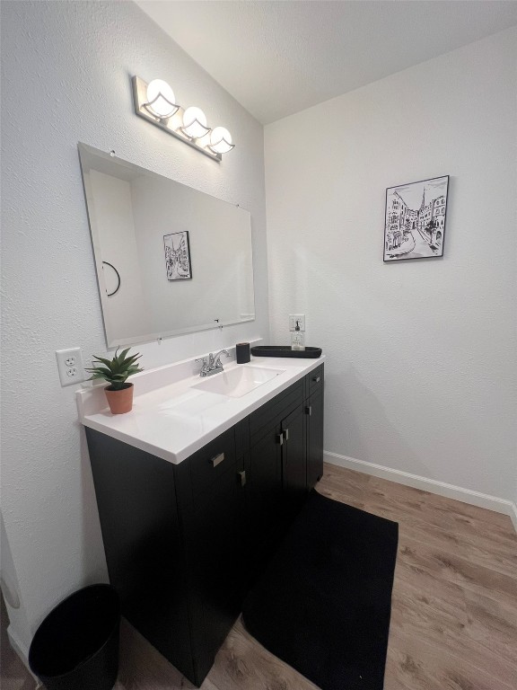 bathroom featuring vanity and hardwood / wood-style flooring