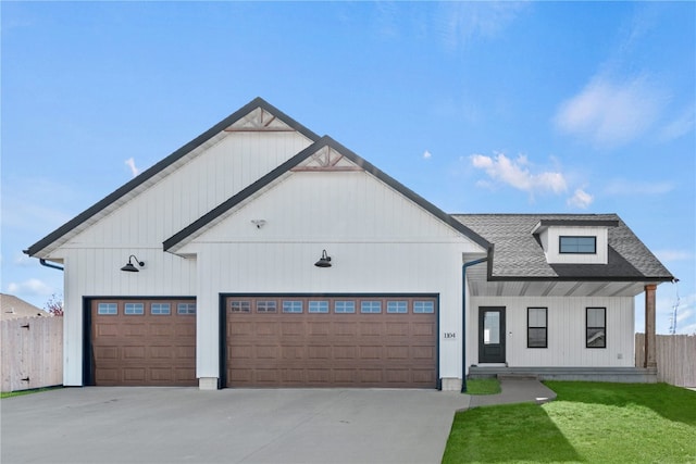 modern farmhouse featuring a front lawn and a garage