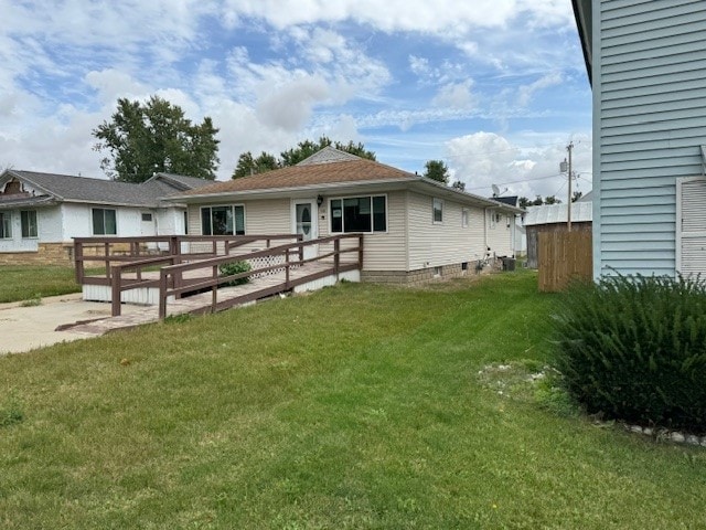 rear view of property with a lawn