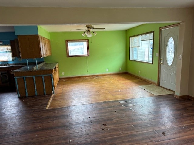 kitchen with dark wood-type flooring and ceiling fan