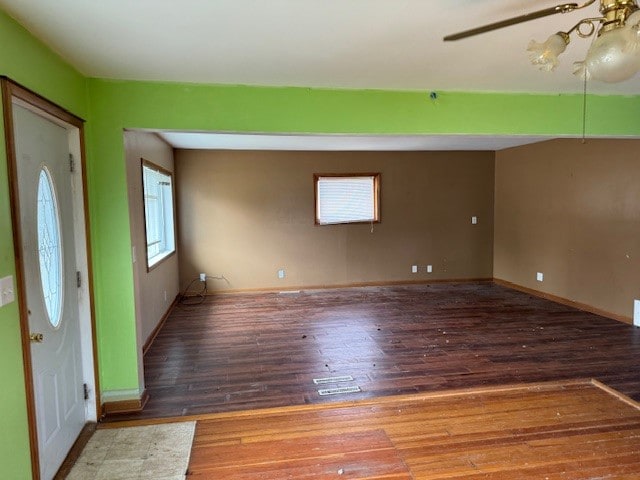 foyer entrance featuring dark wood-type flooring and ceiling fan