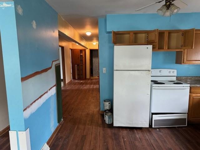kitchen with dark wood-type flooring, a ceiling fan, brown cabinets, and white appliances