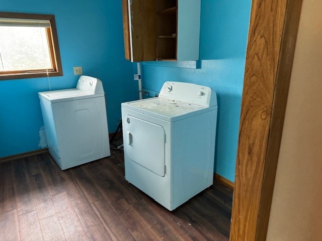 washroom with washing machine and clothes dryer and dark hardwood / wood-style flooring