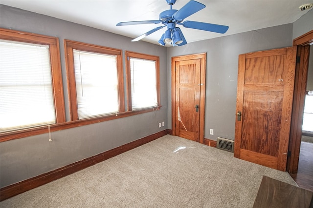 unfurnished bedroom featuring light colored carpet and ceiling fan