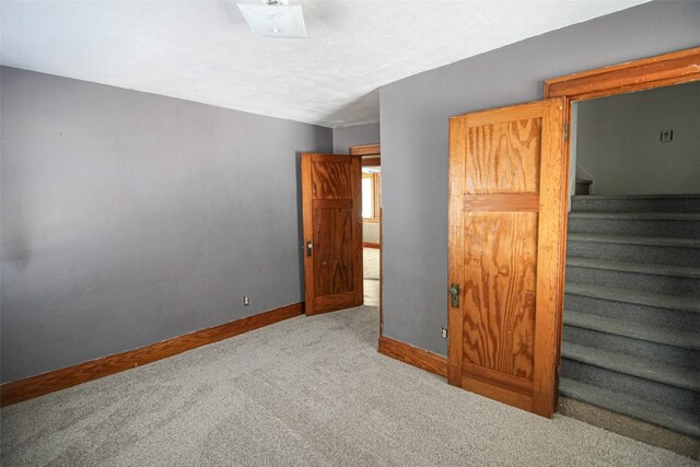 unfurnished bedroom featuring light colored carpet