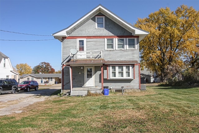 view of front of home featuring a front yard and central air condition unit