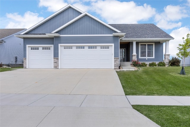 craftsman-style home with a garage and a front lawn