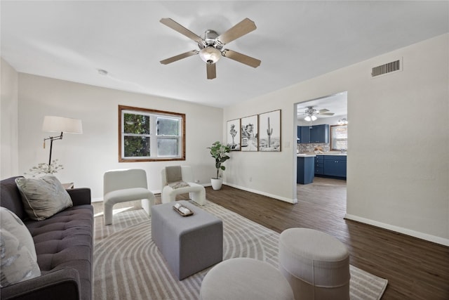 living room with ceiling fan and dark hardwood / wood-style floors