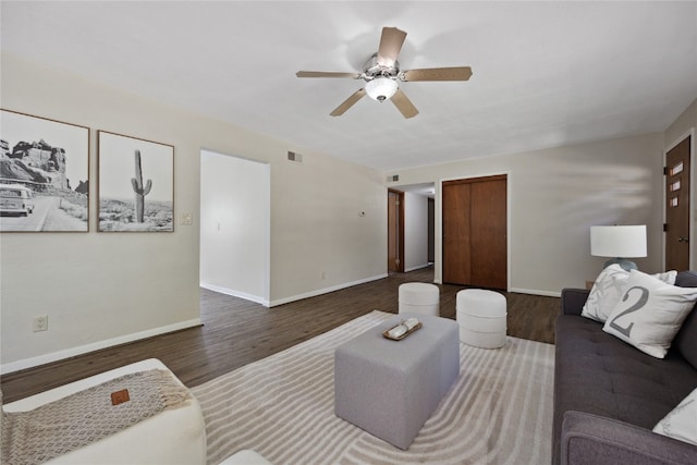 living room with dark hardwood / wood-style floors and ceiling fan