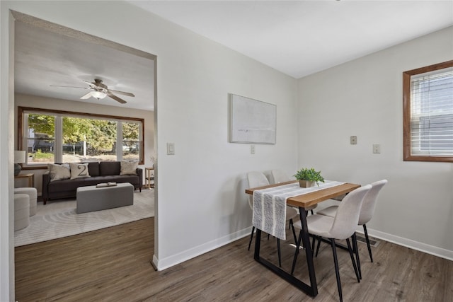 dining area featuring dark wood-type flooring and ceiling fan