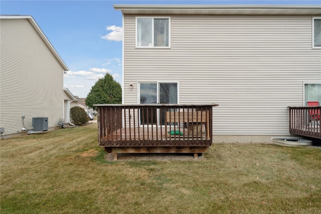 back of house featuring a wooden deck, central air condition unit, and a lawn