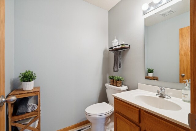 bathroom featuring toilet and vanity