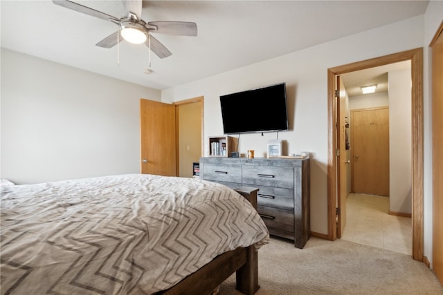 bedroom featuring light colored carpet and ceiling fan