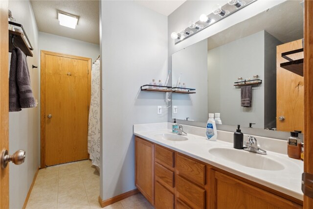 bathroom featuring vanity, a shower with shower curtain, and tile patterned flooring