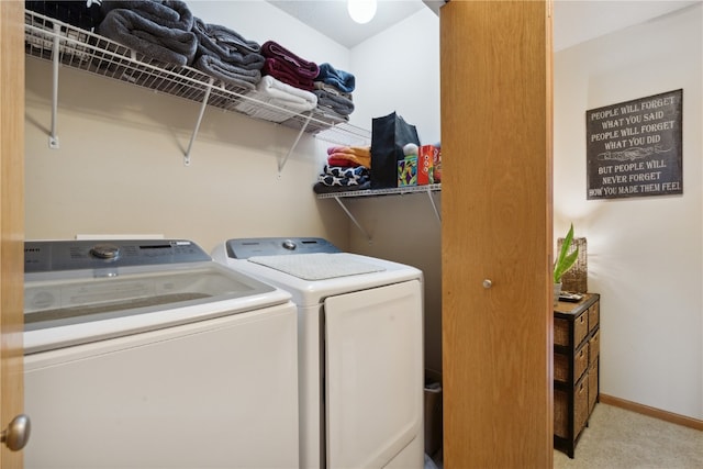 laundry room featuring washer and clothes dryer and light carpet