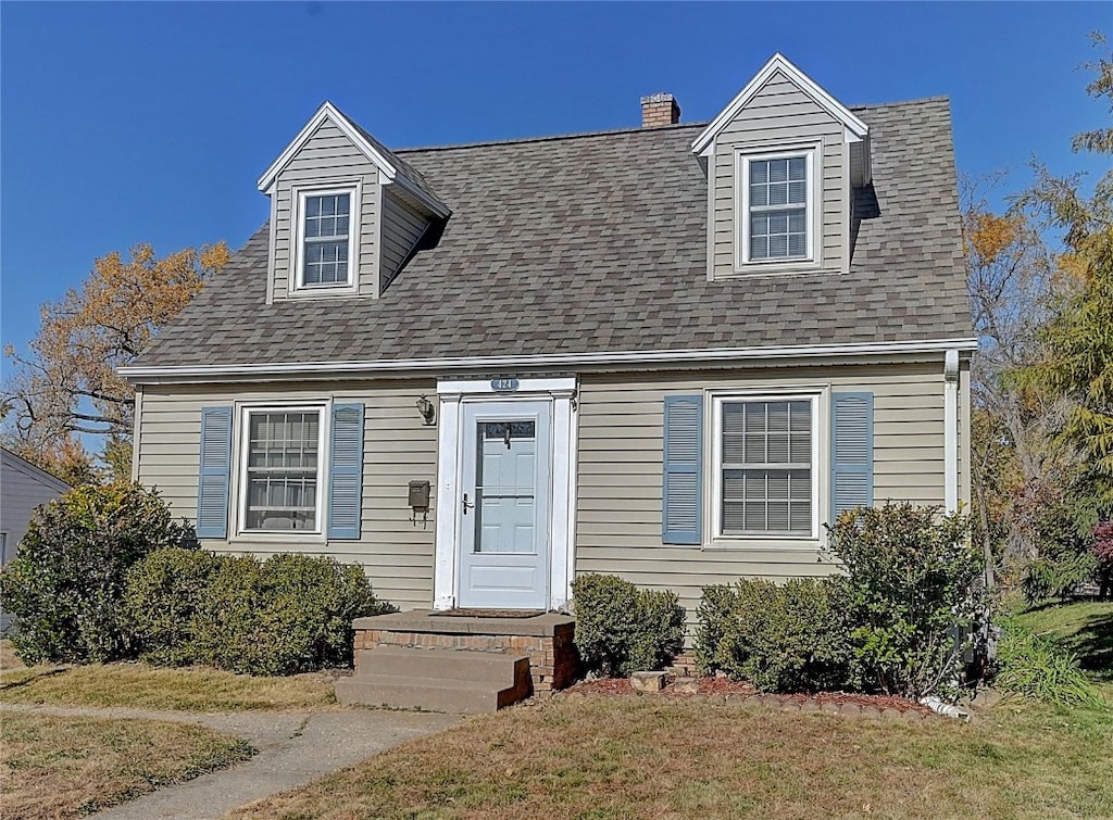 cape cod-style house with a front lawn