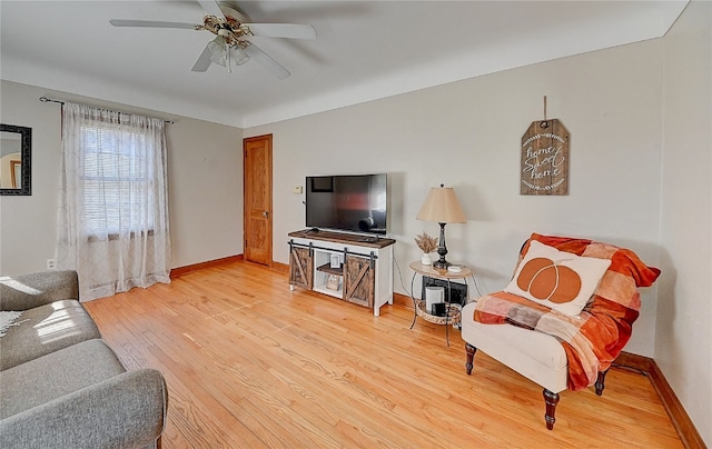 living room featuring ceiling fan and wood-type flooring