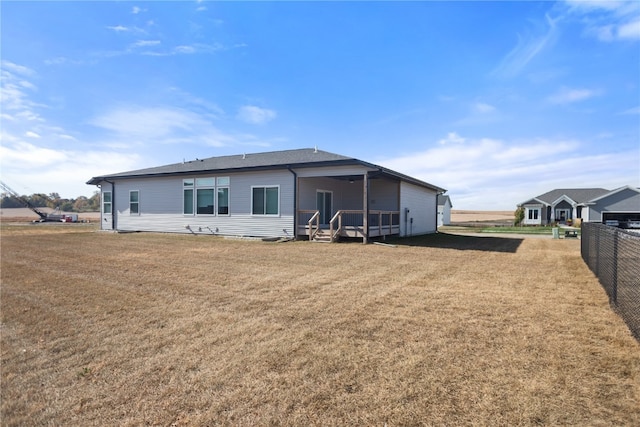 rear view of house with a lawn