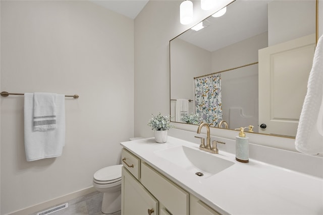 bathroom featuring vanity, toilet, and tile patterned floors