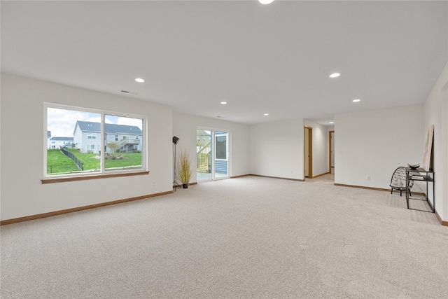 carpeted empty room with plenty of natural light