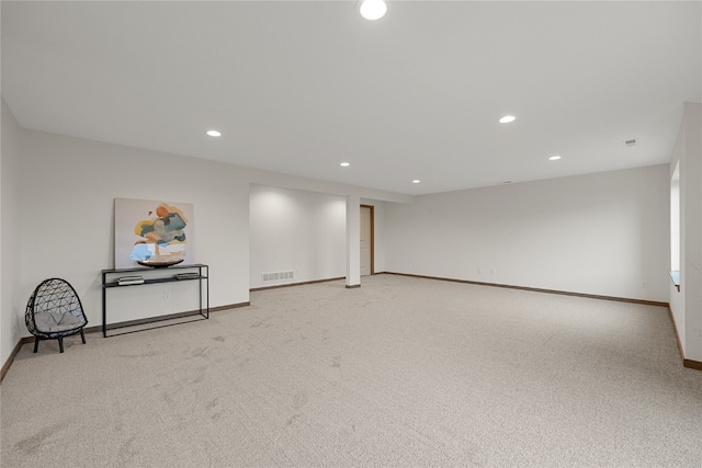 spare room featuring light colored carpet