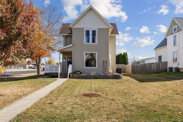 view of front property with central air condition unit and a front lawn