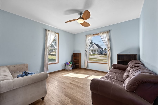 living room featuring light hardwood / wood-style floors, plenty of natural light, and ceiling fan