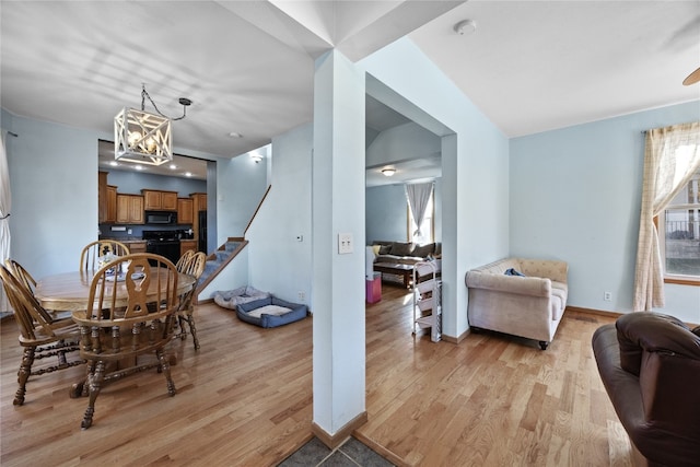 dining room featuring light hardwood / wood-style flooring and an inviting chandelier