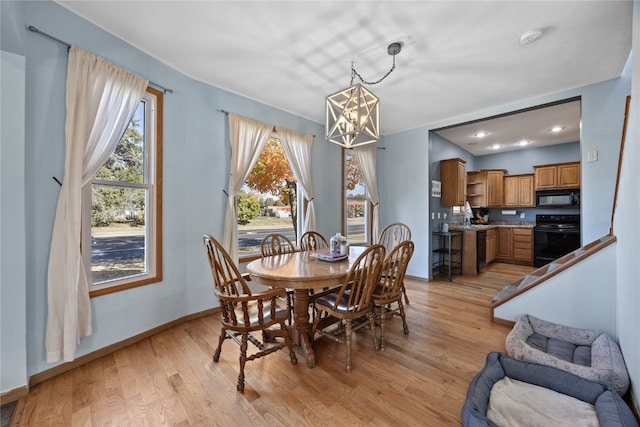 dining room featuring light hardwood / wood-style flooring and an inviting chandelier