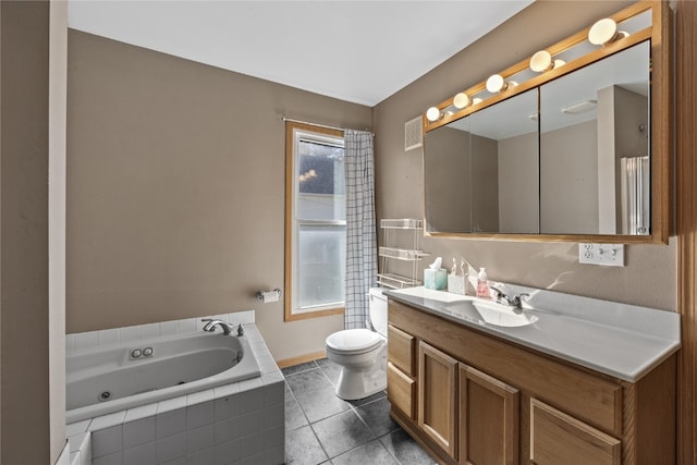 bathroom with vanity, a relaxing tiled tub, toilet, and tile patterned flooring