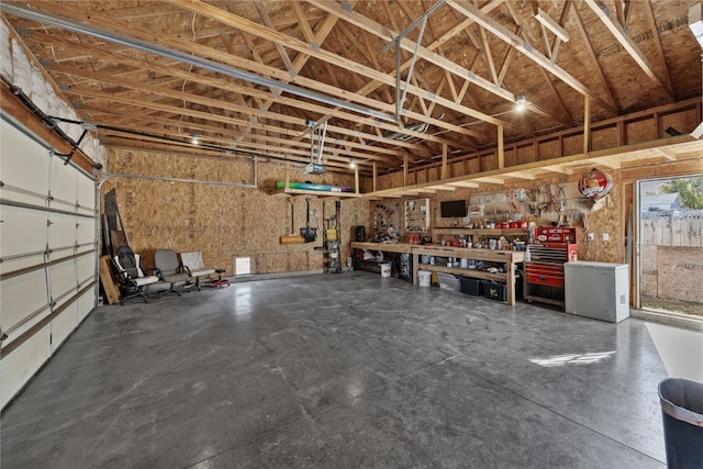 garage featuring a workshop area and fridge