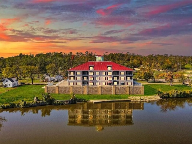 1871 Ellis Blvd NW Unit 202, Cedar Rapids, IA 52405 - back of property at dusk with a water view, a yard, and metal roof
