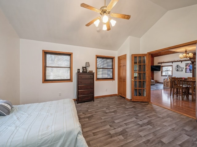 bedroom featuring dark wood-type flooring, high vaulted ceiling, and ceiling fan with notable chandelier