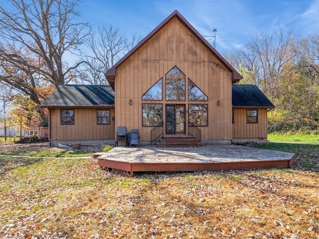 back of house with a deck