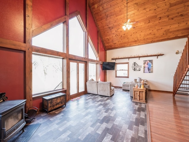 additional living space featuring wood ceiling, hardwood / wood-style floors, ceiling fan, high vaulted ceiling, and a wood stove