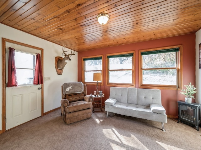 living area with light carpet, wood ceiling, and a wood stove