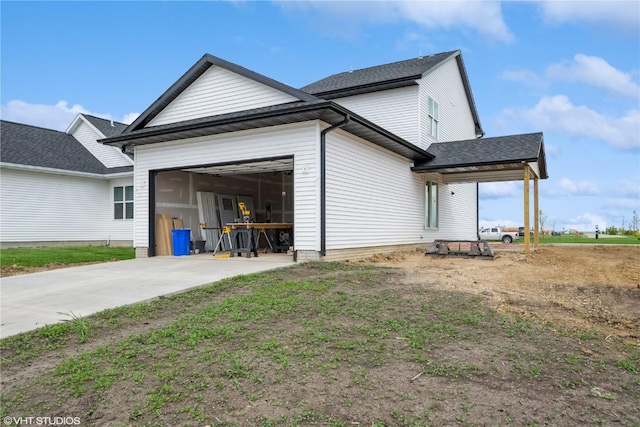 2734 Rookwood Ln, Marion, IA 52302 - view of property exterior with an attached garage, roof with shingles, and concrete driveway