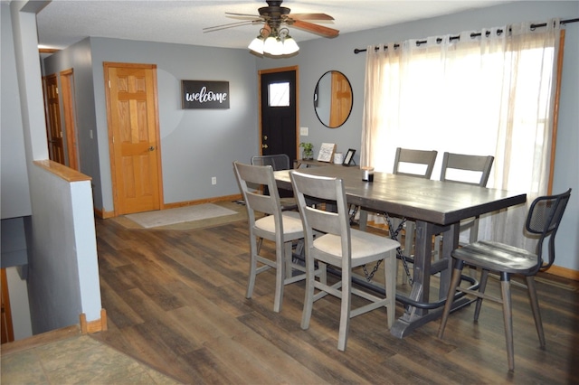 dining room with ceiling fan, dark wood-type flooring, and a wealth of natural light